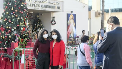 Families take pictures outside St Joseph's church in Mushrif, Abu Dhabi.