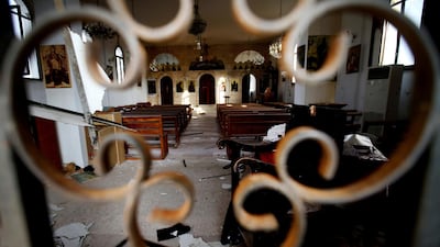 The altar of Judeida church is seen damaged by mortar shell, at the Christian village of Judeida, in Idlib province, Syria. The Qatar-based Syrian Network for Human Rights, a Syrian war monitor associated with the opposition said in its report, that over 120 Christian places of worship have been damaged or destroyed by all sides in the country’s eight-year conflict. AP