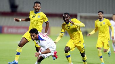 Ryan Mendes of Sharjah takes on Cédric Amissi of Al Taawoun. Chris Whiteoak / The National