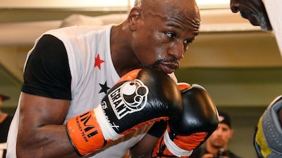 Floyd Mayweather works out with his trainer Roger Mayweather at the Mayweather Boxing Club on Tuesday ahead of his May 3 fight against Marcos Maidana. Ethan Miller / Getty Images / AFP / April 22, 2014