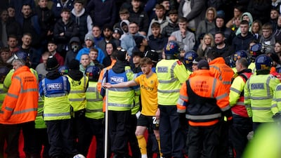 Wolverhampton Wanderers' Tommy Doyle attempts to take a corner while surrounded by police officers and stewards during the Emirates FA Cup fourth round match at The Hawthorns, West Bromwich. Picture date: Sunday January 28, 2024. PA Photo. See PA story SOCCER West Brom. Photo credit should read: Bradley Collyer/PA Wire. RESTRICTIONS: EDITORIAL USE ONLY No use with unauthorised audio, video, data, fixture lists, club/league logos or "live" services. Online in-match use limited to 120 images, no video emulation. No use in betting, games or single club/league/player publications.