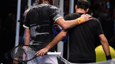 Stefanos Tsitsipas, left, and Roger Federeafter the match. AFP