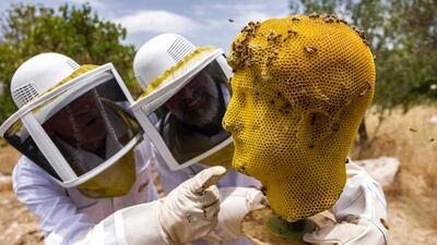 Bees buzz around a 3D-printed wax statue of the Roman emperor Hadrian in Jerusalem. AFP