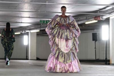 A model walks in a gown made from metallic jacquard for the Edward Crutchley spring/summer 2023 show, which was held in an underground car park. AFP