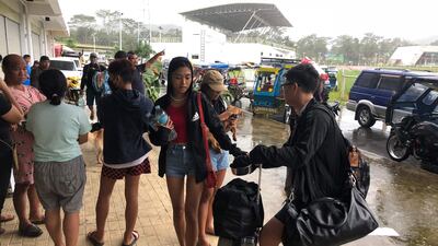 Local tourists with their belongings arrive to take shelter at a sports complex turned into an evacuation centre in Dapa town, Siargao island. Photo: AFP