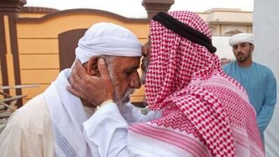 Saeed Ali Saeed Al Yammahi (R) who lost a son in an auto accident one and a half years ago offers his condolences to Saeed Ali Qasep Al Yammahi (L) whose two sons, Khalid, 13 and Sultan, 14 drowned in a sandpit.