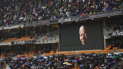 The face of Nelson Mandela is shown on a large billboard during his memorial service at the FNB stadium in Johannesburg. Ben Curtis / AP