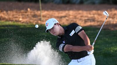 Si Woo Kim hits out of sand onto the ninth green. USA Today