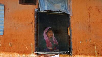 A woman looks out from a window during a protest against the recent killings in Kashmir, in Srinagar, India, on September 16, 2016. Danish Ismail / Reuters