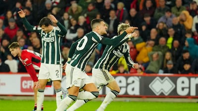 Manchester United's Diogo Dalot, centre, celebrates after scoring his side's second goal during the English Premier League match between Sheffield United and Manchester United. AP