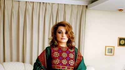 A woman poses in traditional Afghan attire, in Kabul, Afghanistan, 2005, in this picture obtained from social media. Dr. Bahar Jalali/via Reuters