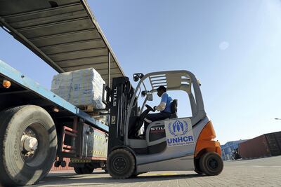 Workers loading humanitarian aid from the UNHCR warehouses in Dubai to be taken to Bangladesh to support of Rohingya refugees. Satish Kumar for The National