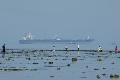 Tourists watch marine life, with the MT Desert Kite oil tanker carrying Russian oil in the background, at Narara Marine National Park in the Arabian Sea, Gujarat, India. REUTERS