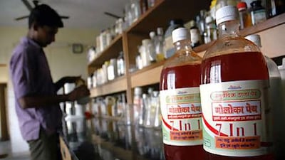 Bottles of Gauloka Peya, a drink containing traces of cow urine, line shelves at the Kanpur office of the Hindu group Gau Seva Sangh.