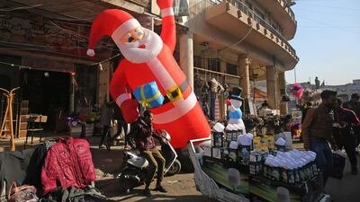 An inflatable Santa Claus is displayed outside a shop in Baghdad's Tahrir Square. AFP