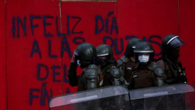 Police stand guard during a protest against the Government of President of Chile Sebastian Pinera on Police Day at Plaza Baquedano in Santiago, Chile. Protesters were dispersed by the Special Forces for breaking curfew. EPA