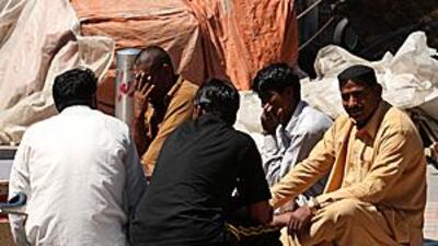 Dhow workers mingle during their lunch break yesterday.