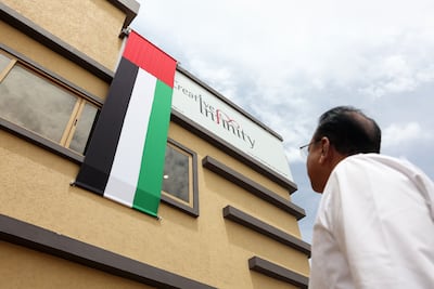 A UAE flag is proudly displayed at a building in Dubai. Chris Whiteoak / The National
