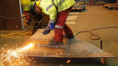 A welder at Harland & Wolff shipyard in Belfast. Much of the downward pressure on input prices came from a widespread fall in raw material costs. PA