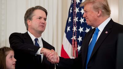 US Judge Brett Kavanaugh shakes hands with US President Donald Trump after being nominated to the Supreme Court in the East Room of the White House on July 9, 2018 in Washington, DC. AFP