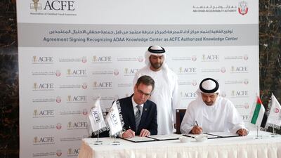 Bruce Dorris, the US-based president and chief executive of the Association of Certified Fraud Examiners (left) signs an agreement with Hamad Al Hurr Al Suwaidi (right), chairman of the Abu Dhabi Accountability Authority, to certify the AADA's fraud identification courses. Courtesy of Abu Dhabi Accountability Authority