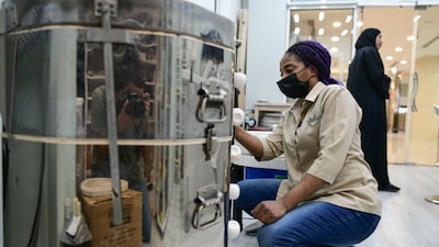 Wisdom fires up the kiln to bake the ceramics.