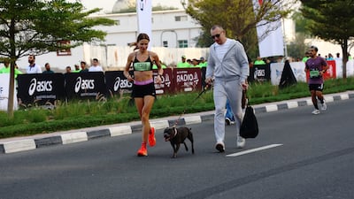 Runners and canine support in action during the Dubai Marathon 2026