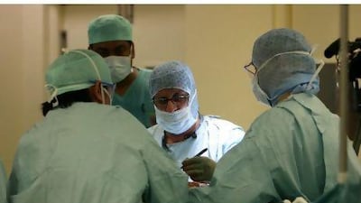 Kneeling in worship puts a strain on standard knee implants. Above, Dr Deepak Bhatia performs knee surgery on Shadmani Perveen at Al Zahra Hospital in Sharjah, providing her with an implant suited to her body and needs.