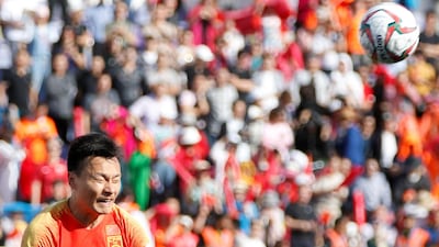 Zhao Xuri heads the ball away for China. EPA