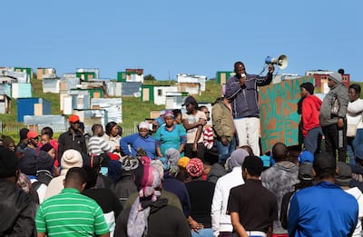 People hold a community meeting after building shacks on a piece of land belonging to the Louiesenhof Wine Estate on August 8, 2018, in Stellenbosch, which is at the centre of the South African wine-producing region. AFP