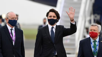 Canadian Prime Minister Justin Trudeau waves as he arrives for the G7 summit in Cornwall. Getty