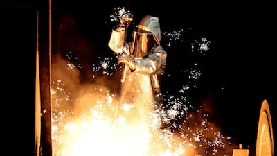 A steel worker takes a steel sample at blast furnace 8 of German corporation ThyssenKrupp in Duisburg, Germany. the firm and India's Tata Steel merger will create Europe's secon- largest steel maker. Friedeman Vogel/EPA