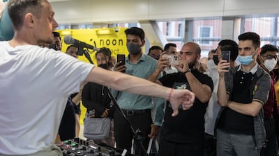 Commuters catch a performance by Christophe Servas at Mall of the Emirates station.