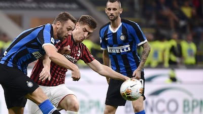 Inter Milan's Dutch defender Stefan de Vrij and AC Milan's Polish forward Krzysztof Piatek go for the ball. AFP