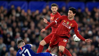 Billy Gilmour puts in a tackle on Takumi Minamino. PA