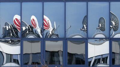 Satellite dishes of Germany’s biggest commercial broadcaster ProSiebenSat.1 Media AG are reflected in the windows of their headquarters in Unterfoehring, near Munich. Michaela Rehle / Reuters