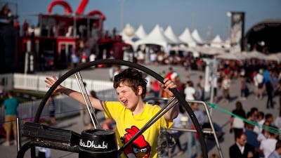 A young boy plays on board a mock-up of the Azzam sailing boat at Volvo's Destination Village. Boats finished the second leg, Cape Town to Abu Dhabi, of the Volvo Ocean Race on Wednesday, Jan. 4, 2012, at the Breakwater Corniche in Abu Dhabi. (Silvia Raz???