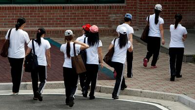 Women walk to class at a state-run shelter for North Korean defectors in Ansung, South Korea. AP Photo