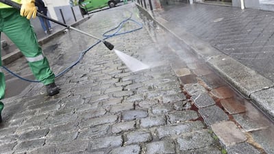 A street cleaner arrives to clean blood from the pavement near a patisserie at the Rue de Charonne in Paris on November 14, 2015, following the series of coordinated attacks. Loic Venace/AFP Photo