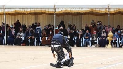 Recruits demonstrate their skills as officials watch.