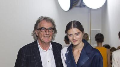 British designer Paul Smith greets the audience after presenting his collection for Spring/Summer 2016 at London Fashion Week in London. AFP