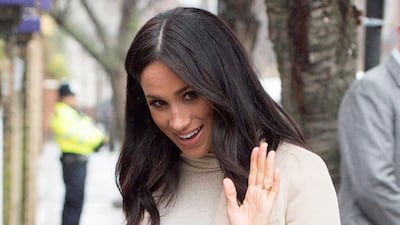 Meghan, Duchess of Sussex, wears a H&M maternity knit dress, Emporio Armani coat and Paul Andrew heels to animal welfare charity Mayhew in London on January 16, 2019. AFP