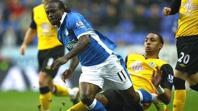 Victor Moses of Wigan is tackled by Steven N'Zonzi of Blackburn. The two sides battled to a 3-3 draw in a 'relegation six-pointer'.