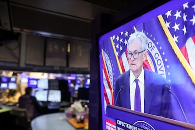 Jerome Powell, chairman of the US Federal Reserve, speaks on TV as traders work the New York Stock Exchange floor. Bloomberg
