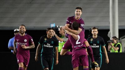 Manchester City's John Stones, top, celebrates his goal with Kyle Walker. Jae C Hong / AP Photo