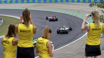 Pirelli hostesses take pictures as drivers compete during the Hungarian F1 Grand Prix at the Hungaroring circuit, near Budapest July 27, 2014. REUTERS/David W Cerny