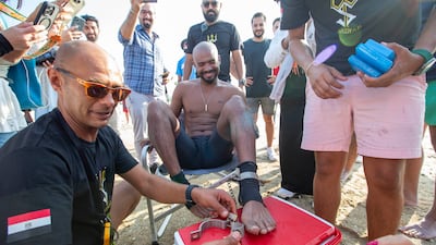 Shebab Allam has completed a 10.7km swim wearing handcuffs and leg irons in Dubai. All photos: Ruel Pableo / The National