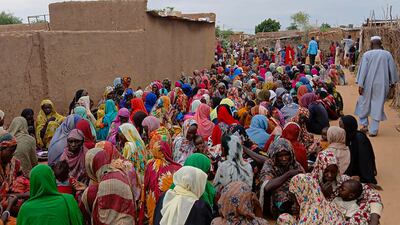 People line up for meals in El Fasher in August. Dozens were killed in a drone strike at a mosque in the city on Friday. AFP