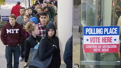 People wait in a line to enter a polling station in Arlington, Virginia. Michael Reynolds / EPA