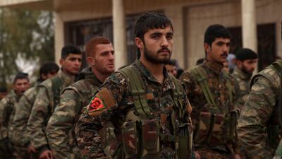 Fighters from the Syrian Democratic Forces (SDF) attend a funeral in the Syrian Kurdish-majority city of Qamishli on December 31, 2018. AFP